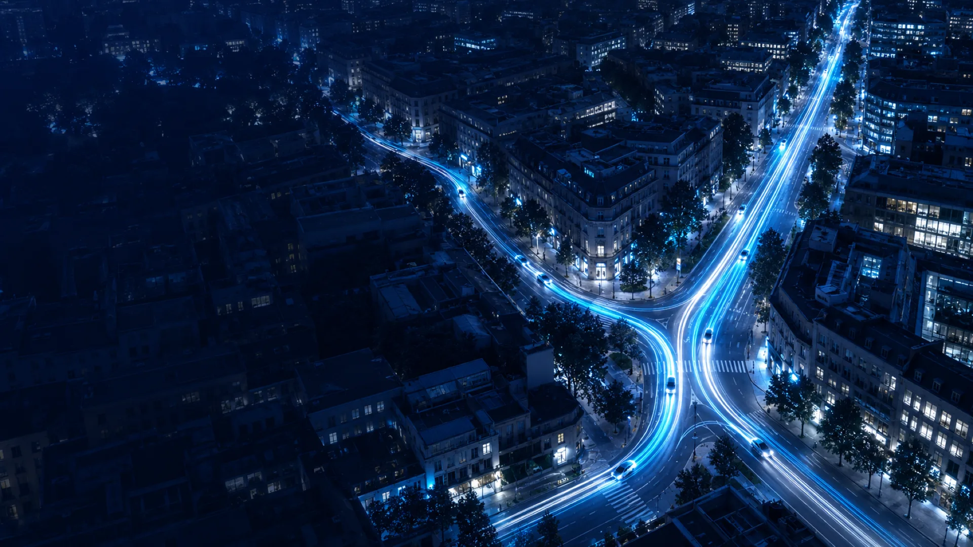 Aerial night view of a city where cyan taxi light trails merge into one shared route